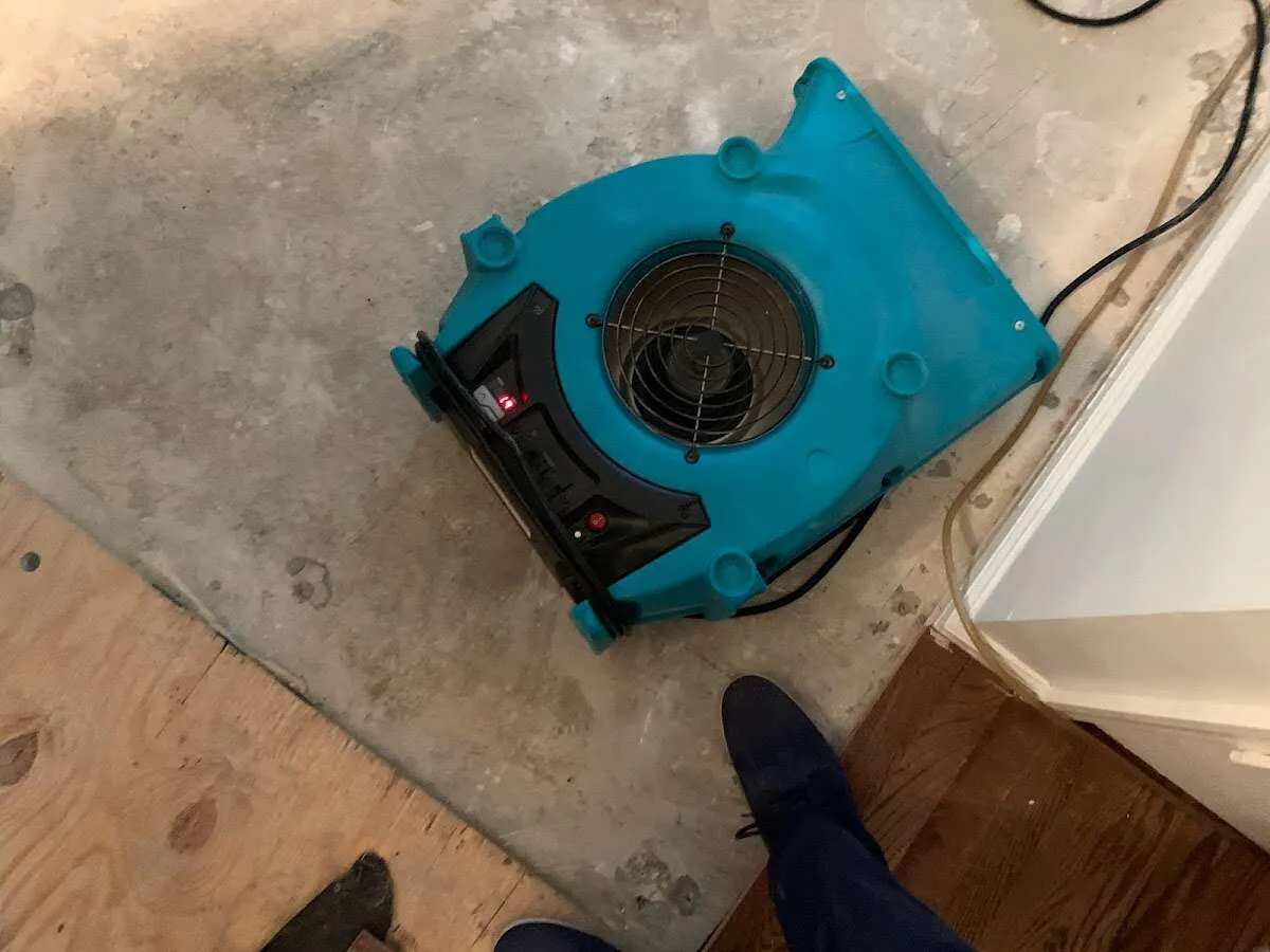 Air mover drying subfloor during Commercial Water Damage Restoration in San Juan